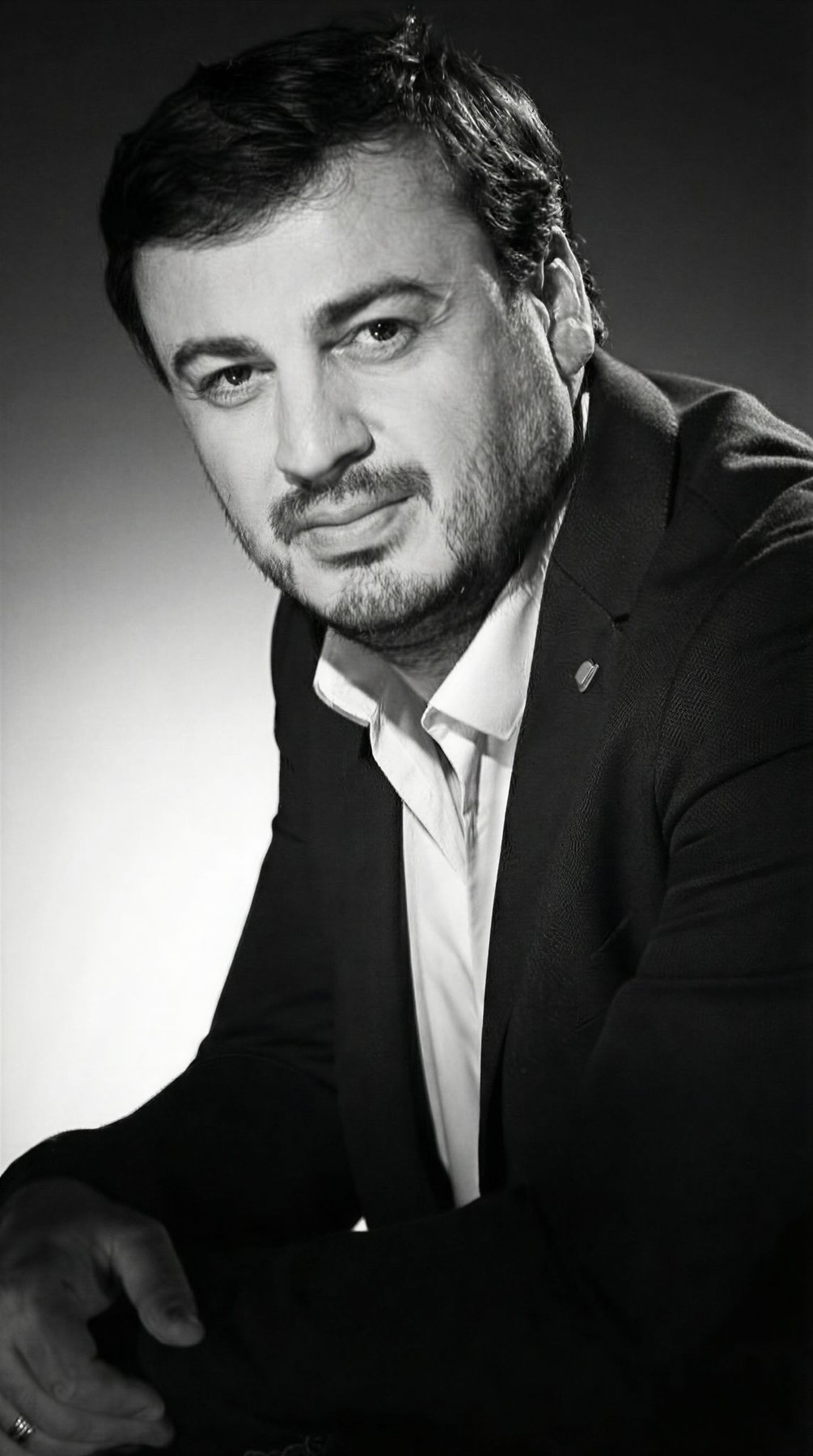 Irakli Kakhidze full-length portrait in dark formalwear